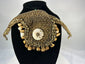 Melanesian ritual adornment featuring cowrie shell and pierced animal teeth