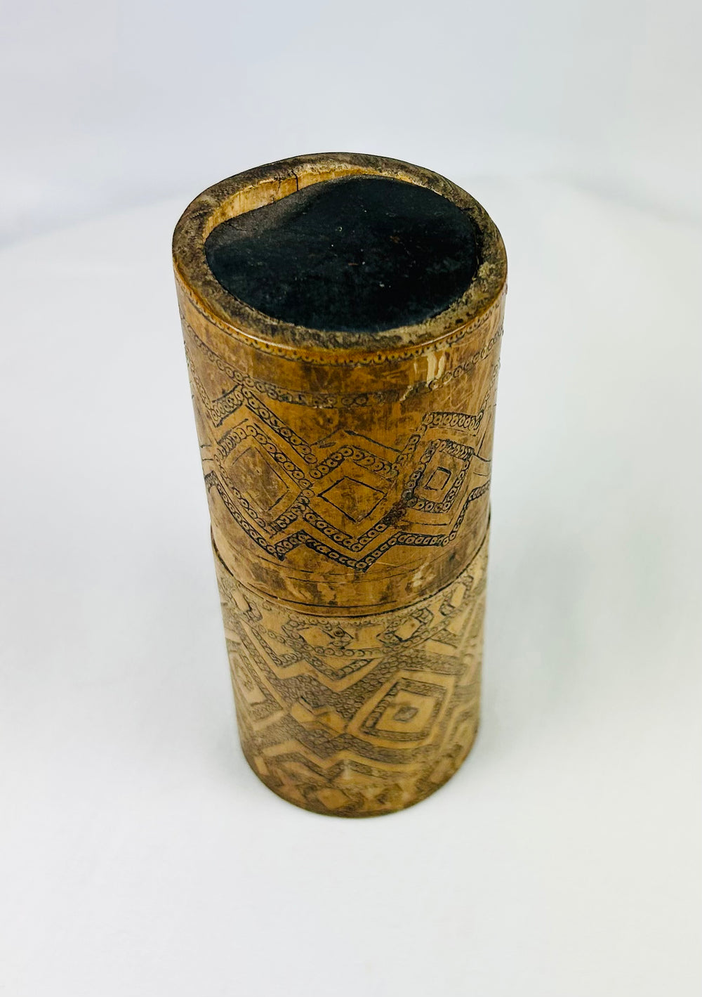 Southeast Asian betel nut container carved from bamboo, decorated with darkened motifs