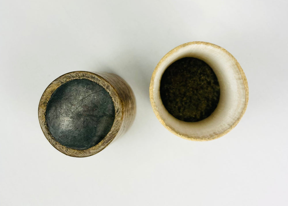 Traditional Southeast Asian carved bamboo betel container on white background