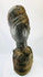 Wooden sculpture from West Africa featuring elongated facial features and natural fiber torso wrap
