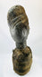 Wooden sculpture from West Africa featuring elongated facial features and natural fiber torso wrap