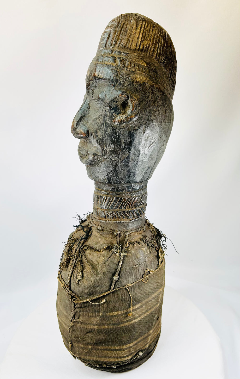 Traditional West African wooden figure, hand-carved with elongated features and organic pigment traces