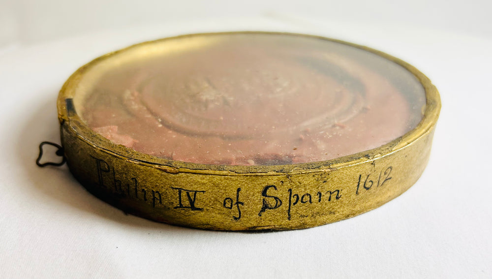 Wax seal of Spain’s Philip IV, red and round, showing enthroned king design