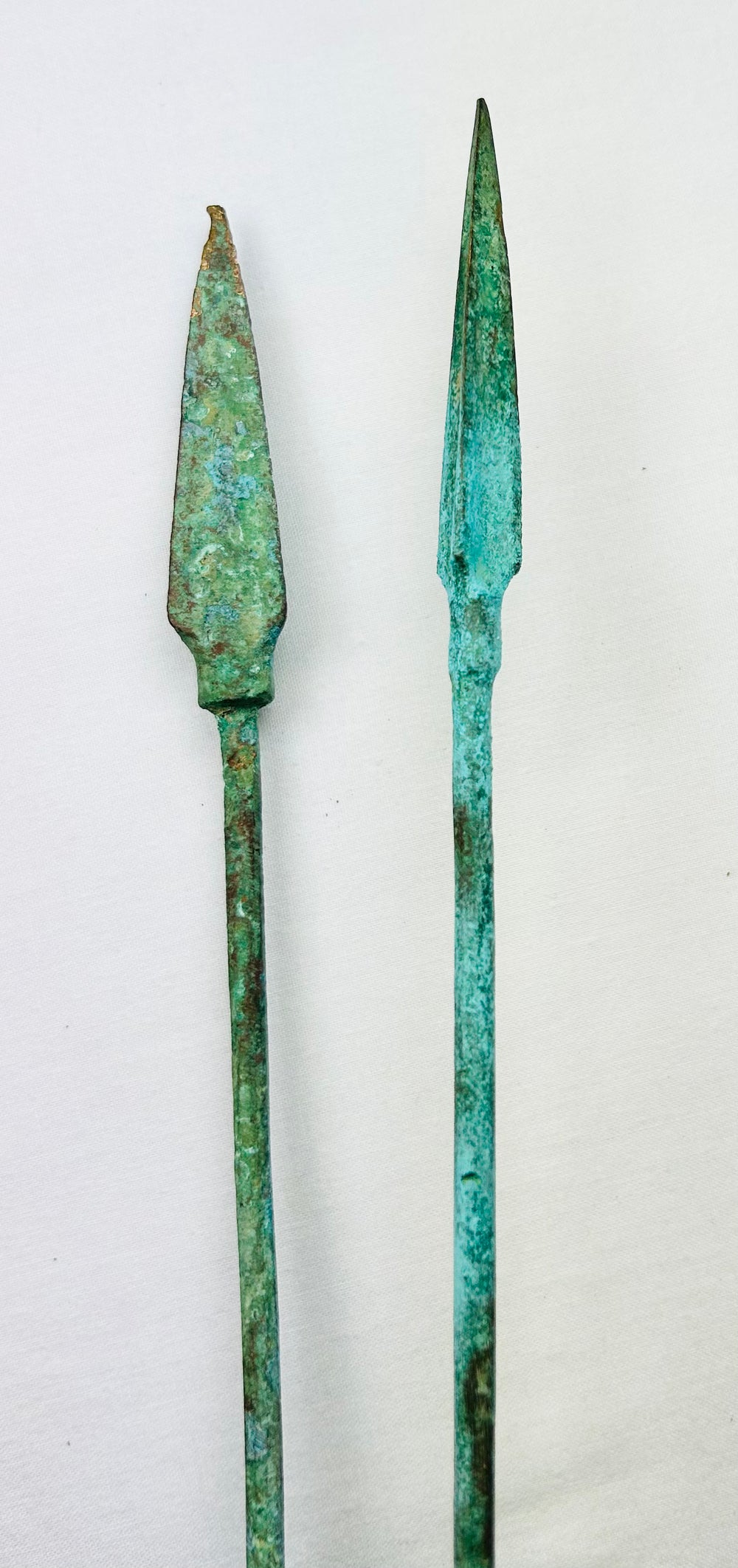 Bronze and Iron Age spearheads mounted on black display stands