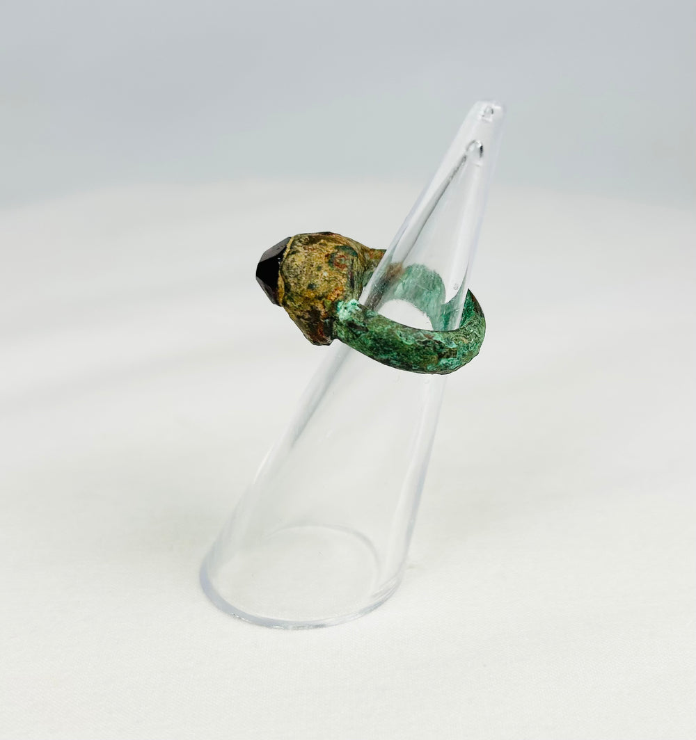 Antique Assyrian bronze ring from 9th–7th century BCE with red garnet