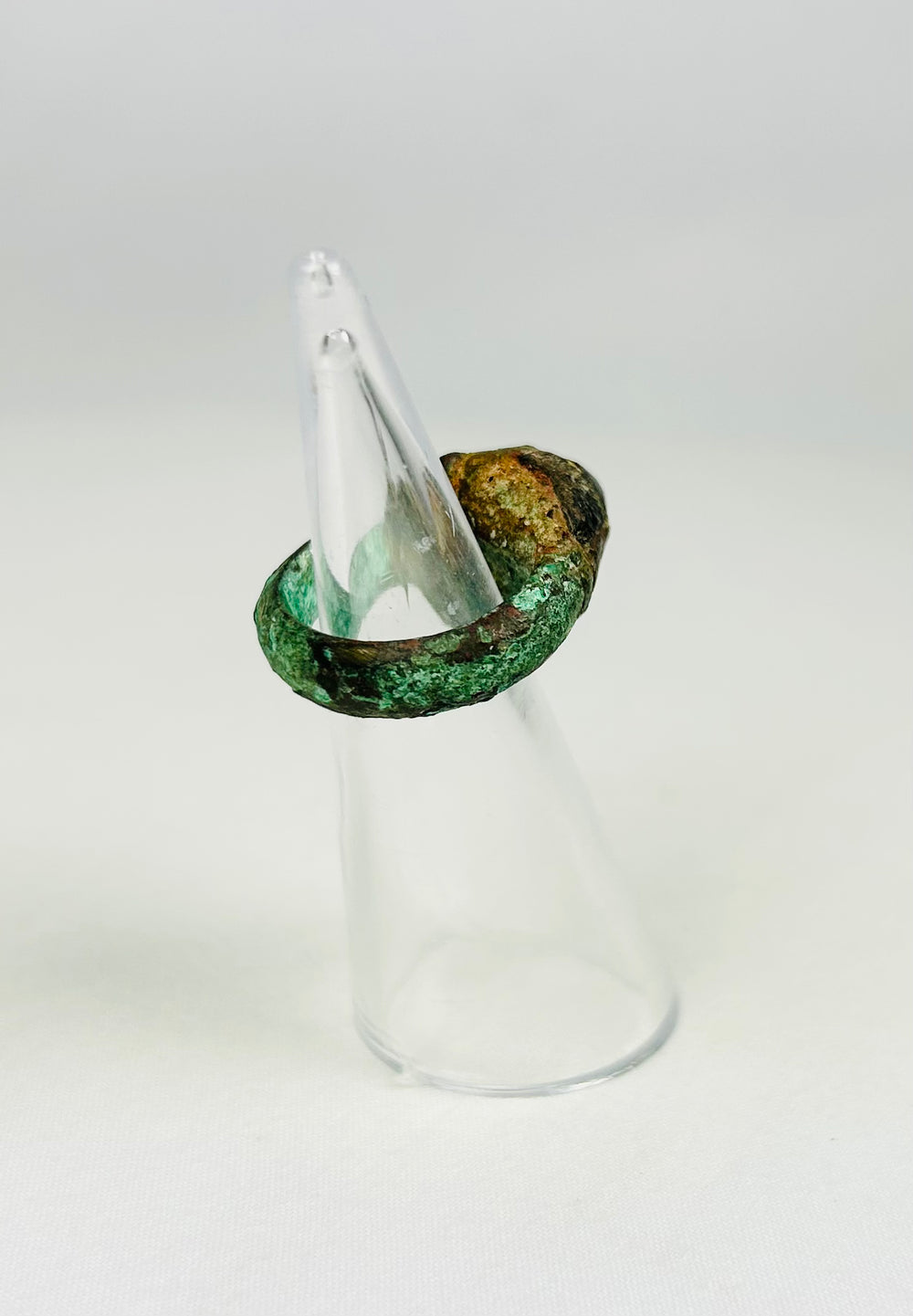 Assyrian bronze ring with deep red gemstone and aged green patina