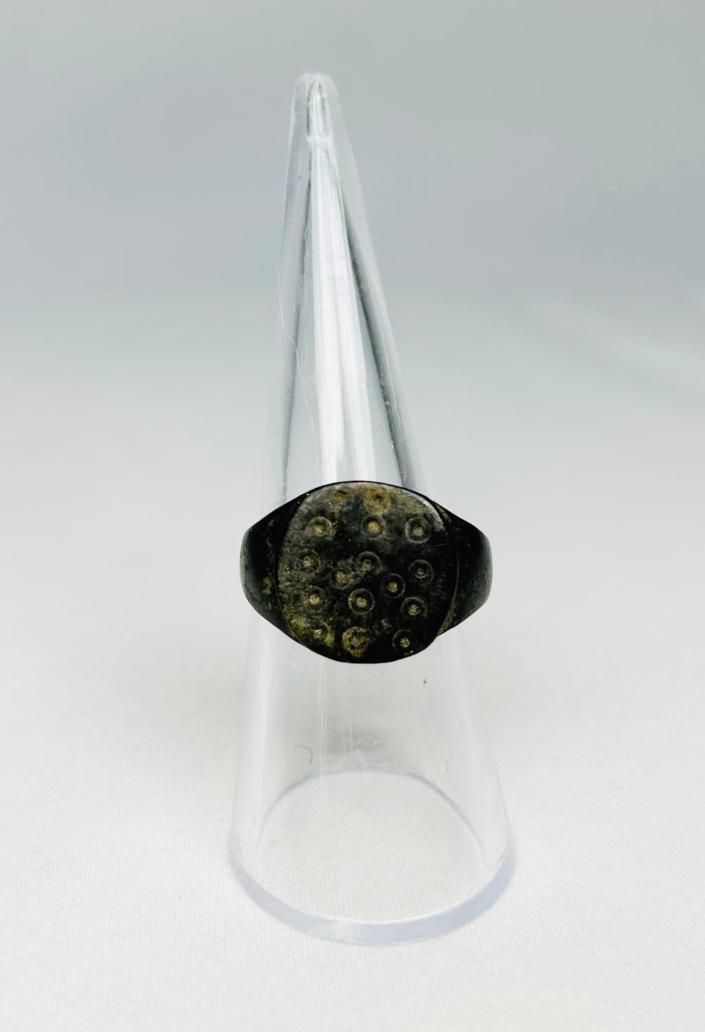 Detailed view of ring-and-dot decoration on a 1st–3rd century Roman bronze ring