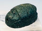 Three-quarter view of blue-green glazed ancient Egyptian faience scarab amulet