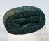 Underside of blue-green Egyptian faience scarab showing carved legs and incised body details