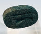 Underside of blue-green Egyptian faience scarab showing carved legs and incised body details