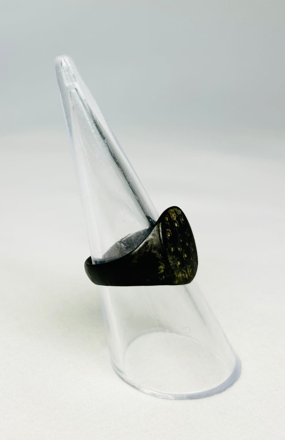 Macro image of an ancient Roman bronze ring emphasizing craftsmanship and age patina