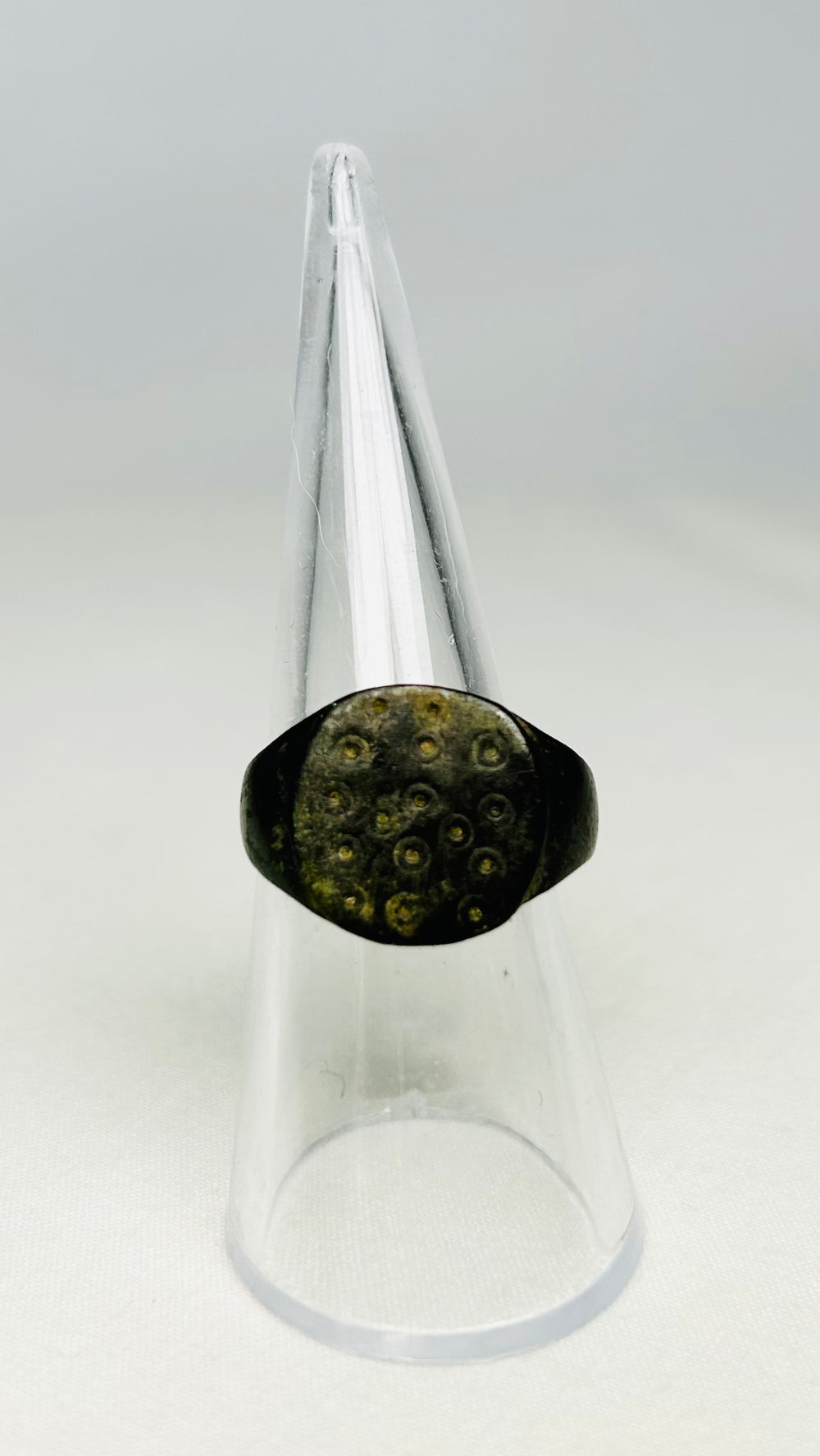 Detailed view of ring-and-dot decoration on a 1st–3rd century Roman bronze ring