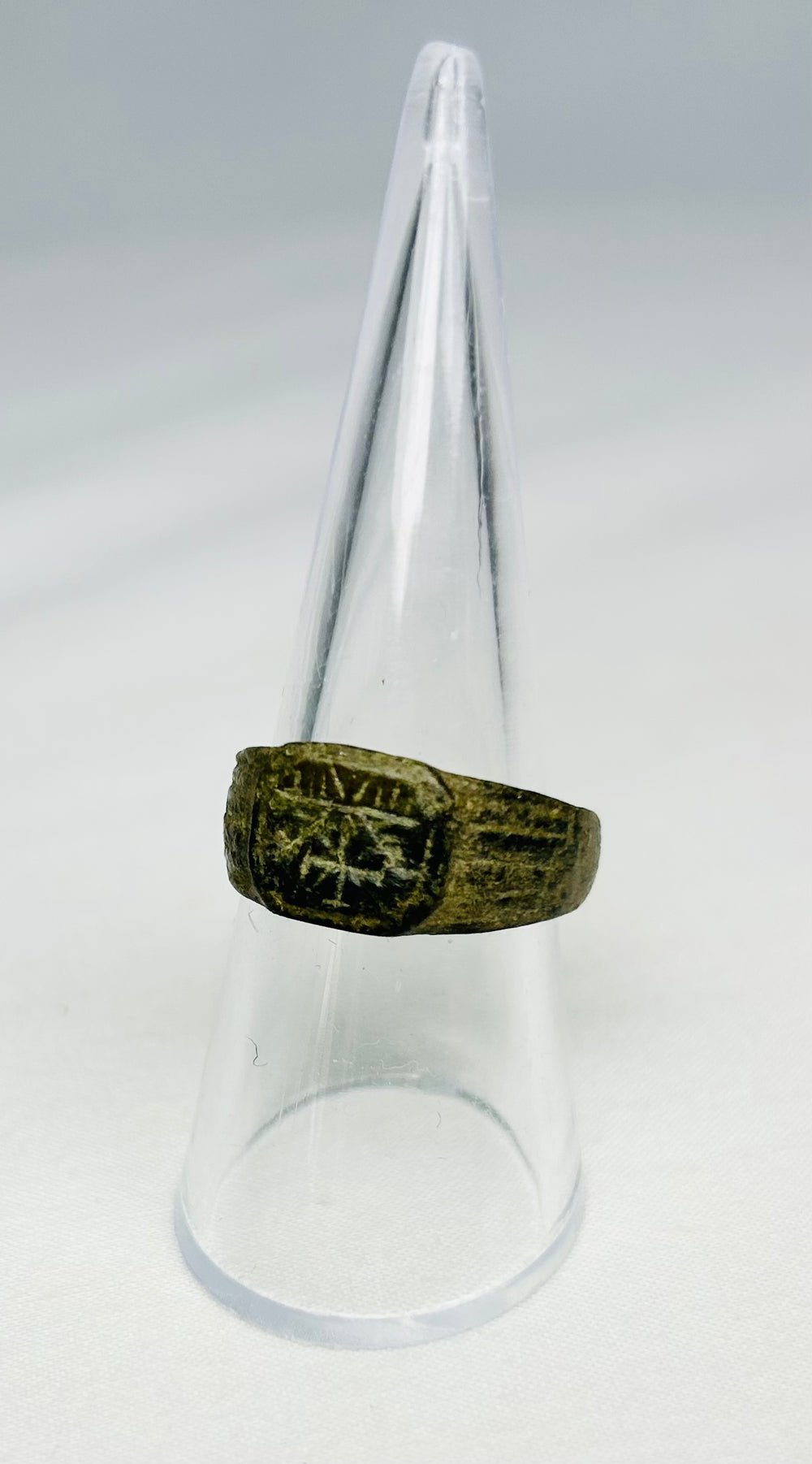 Detailed shot of Roman bronze ring featuring Christogram symbol, early Christian antiquity, circa 1st–4th Century CE, authentic artifact.