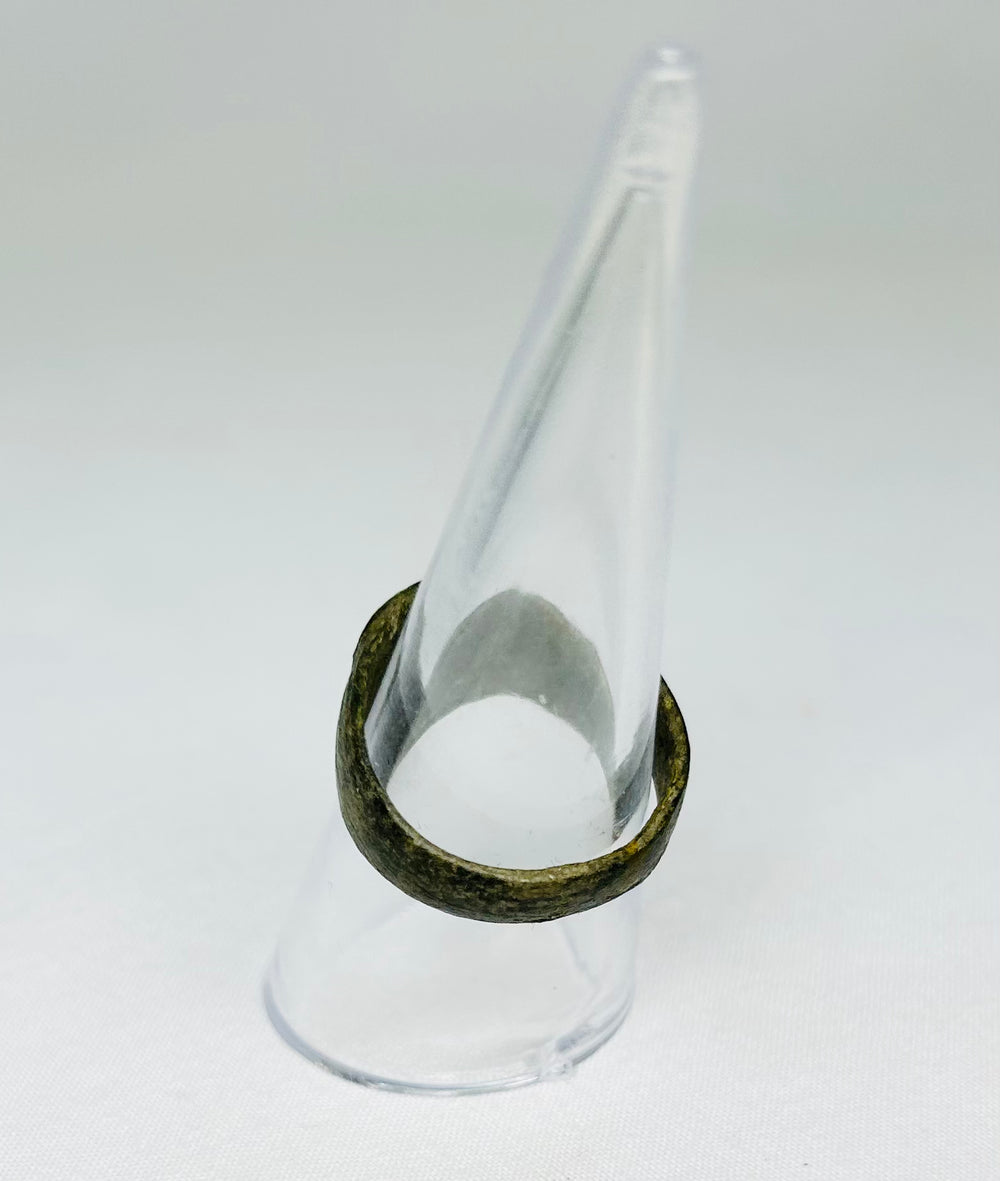 Top view of ancient Roman bronze ring, showing circular bezel and engraved Christogram, 1st–4th Century CE, early Christian artifact.