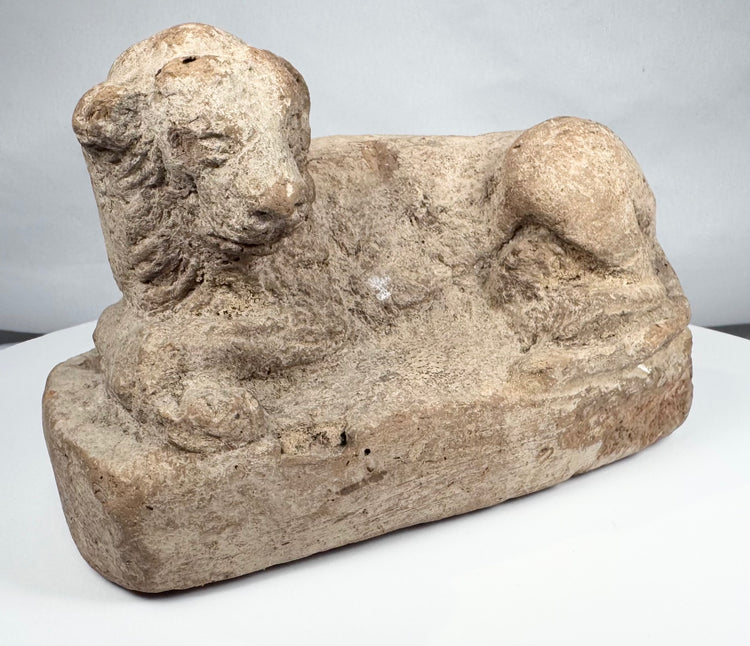 Excavated ancient Egyptian terracotta lion figure with stylized mane and weathered surface
