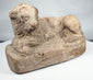 Excavated ancient Egyptian terracotta lion figure with stylized mane and weathered surface