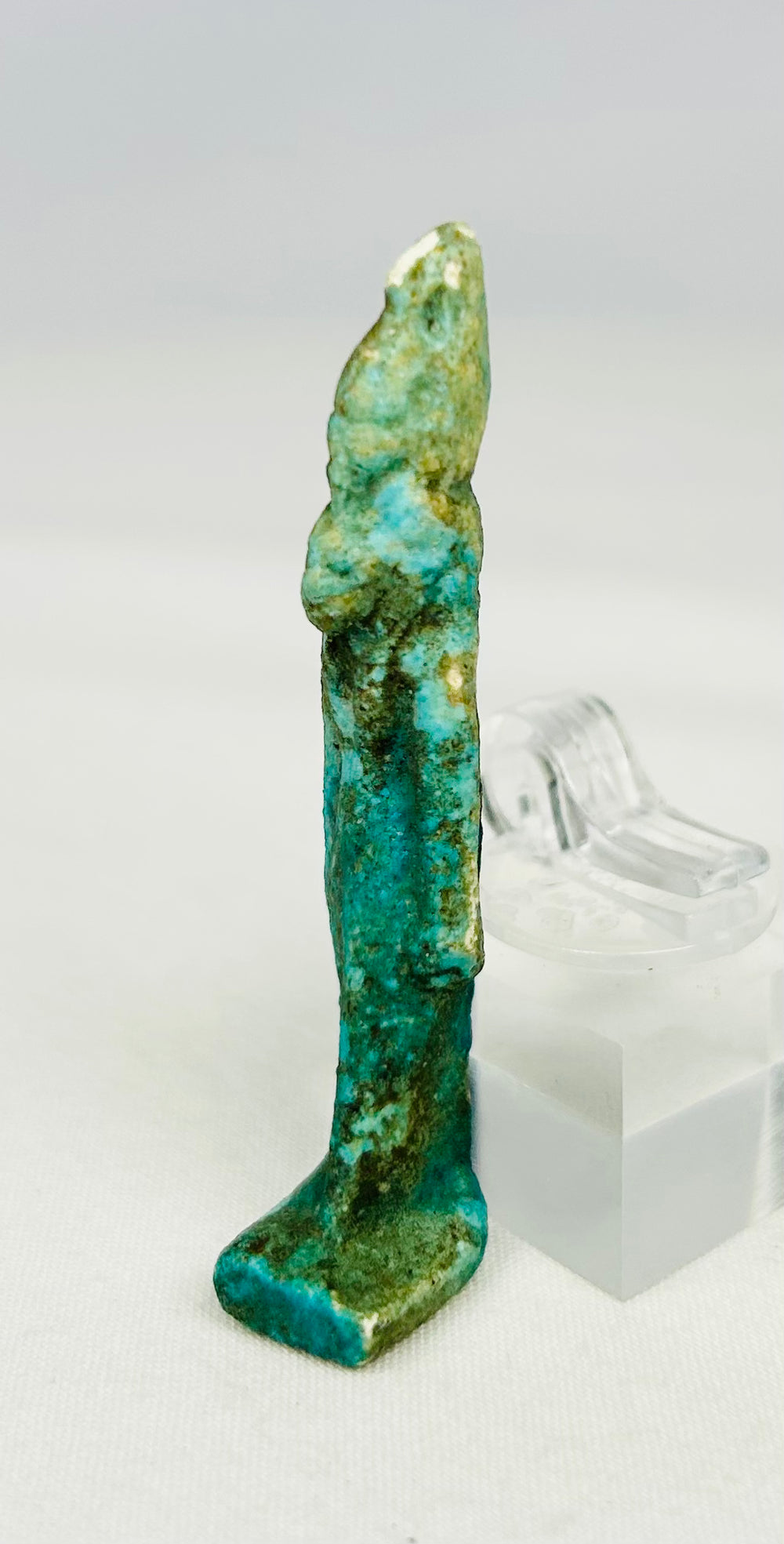 Vibrant turquoise Egyptian amulet of Sekhmet reflecting devotional artistry and symbolism