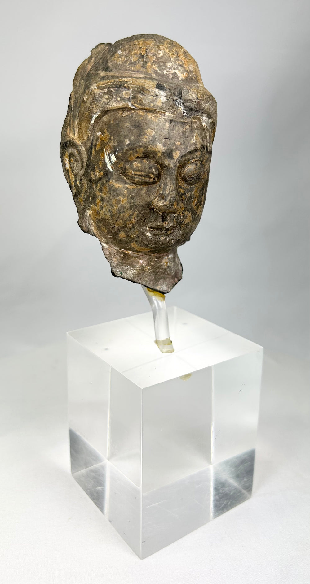 Gandharan Buddhist stone Buddha head fragment with half-closed eyes and naturalistic realism, Silk Road era artifact