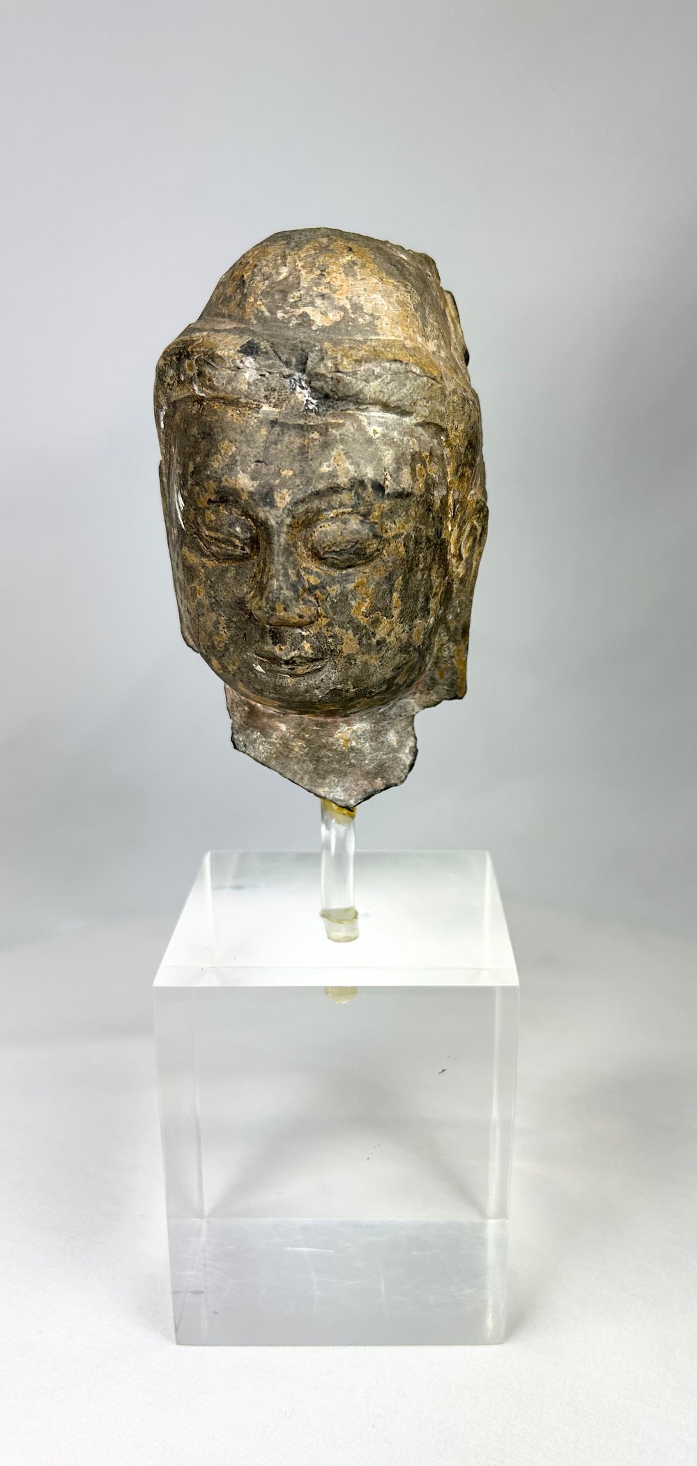 Ancient Gandhara Buddhist sculpture fragment depicting Buddha head, Greco-Roman style, carved stone