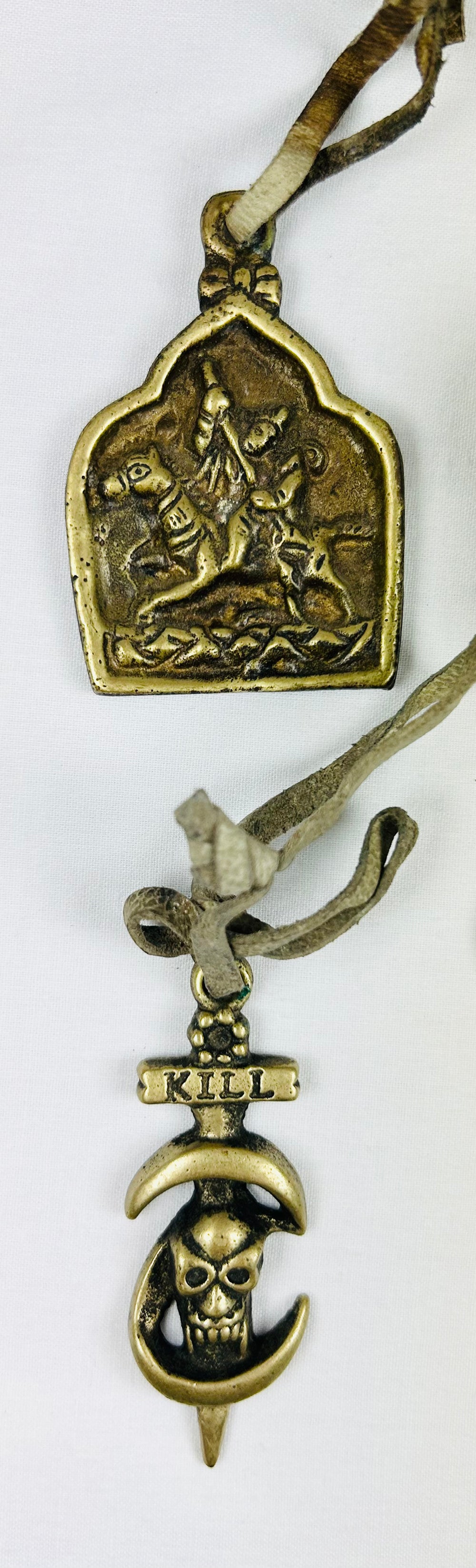 Antique Tibetan protective talismans with sacred imagery and leather cords