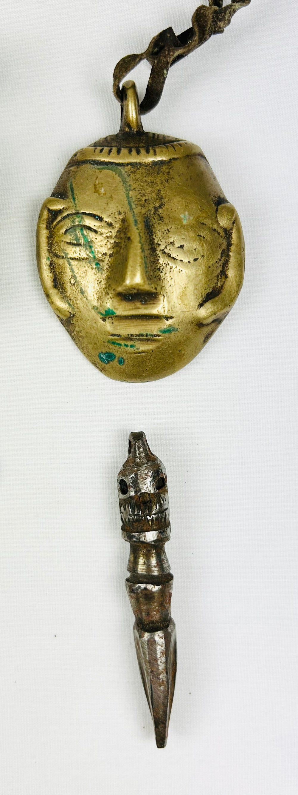 Six Tibetan bronze amulets including religious and symbolic figures