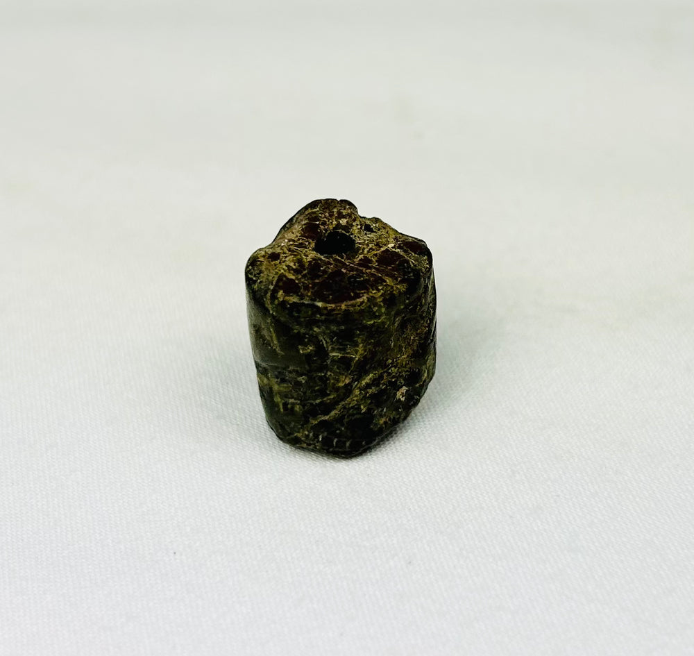 Ancient Egyptian cylindrical bead amulet with protective serpent imagery and carved details