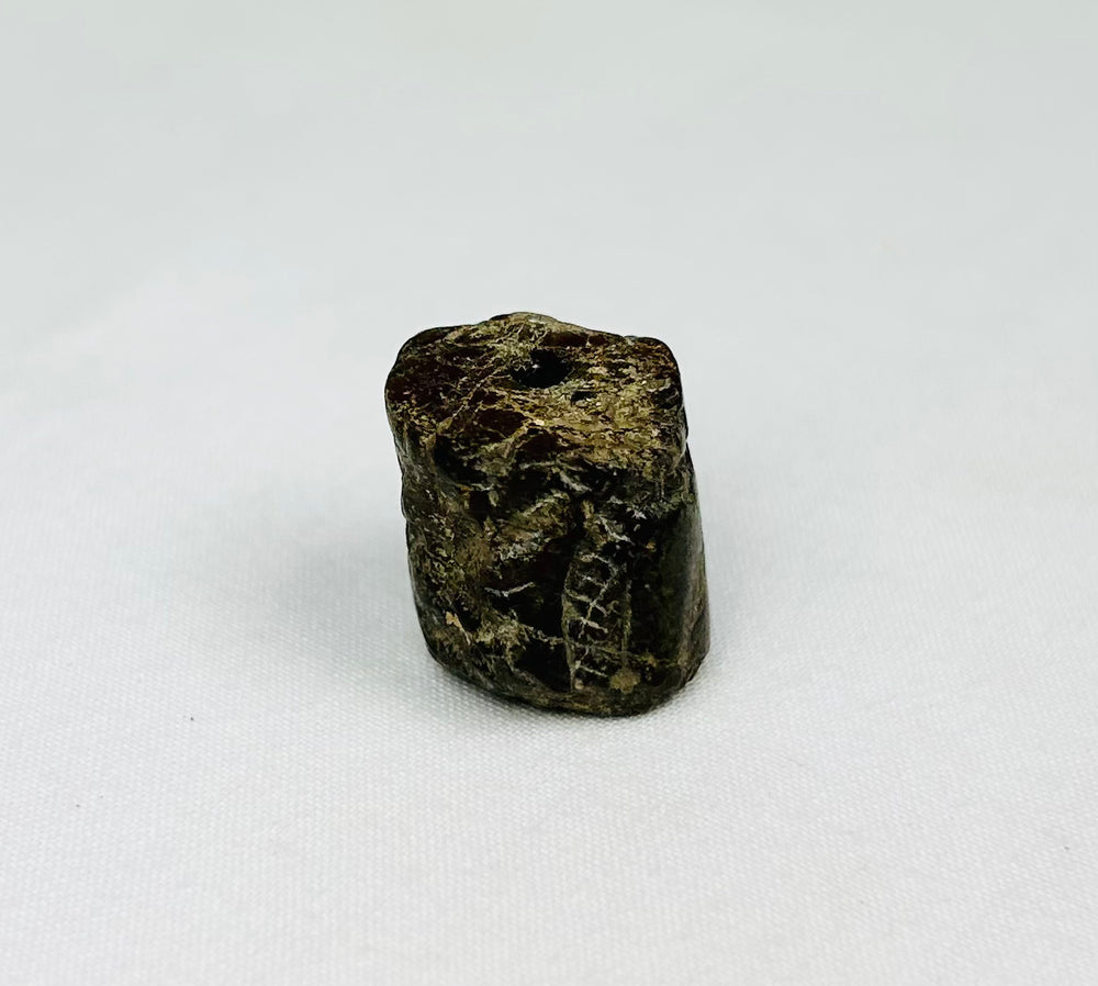 Protective Egyptian snake-head amulet bead showing ancient craftsmanship and spiritual symbolism