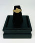 Museum-style photograph of an ancient bronze ring with natural green and brown patina