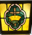 16-inch square stained glass panel, early 20th century, depicting cross and crown motif in colored glass with wooden frame.