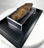 Side profile of Late Period Egyptian mummified hand, showing elongated fingers, resin coloration, and textile wrapping consistent with 700–200 BCE funerary mummification.