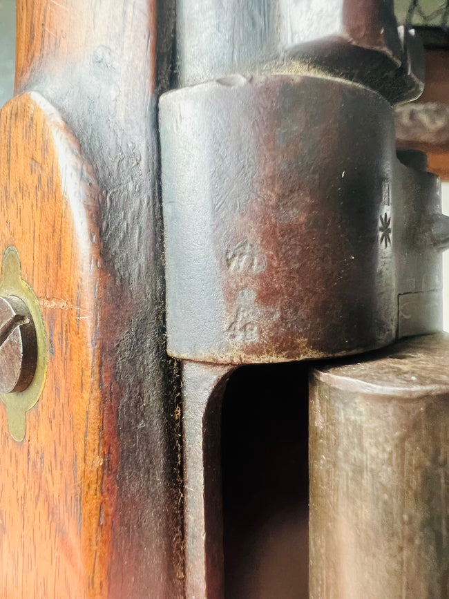 Close-up view of the Snider-Enfield Mk II rifle breech mechanism, showing aged steel components and patinated metal against the original wooden stock.
