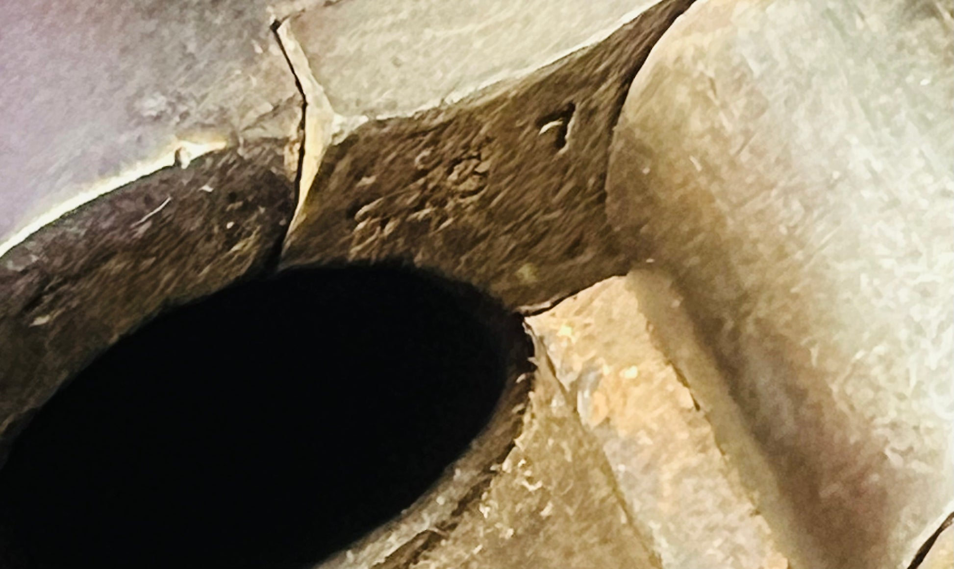 Close-up view inside the breech of a Victorian-era Snider-Enfield rifle, showing the chamber and firing mechanism.