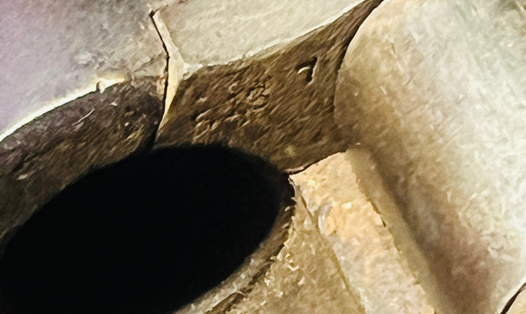 Close-up view inside the breech of a Victorian-era Snider-Enfield rifle, showing the chamber and firing mechanism.