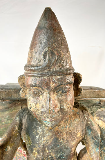Close-up of Garuda statue torso and head — fine bronze patina visible
