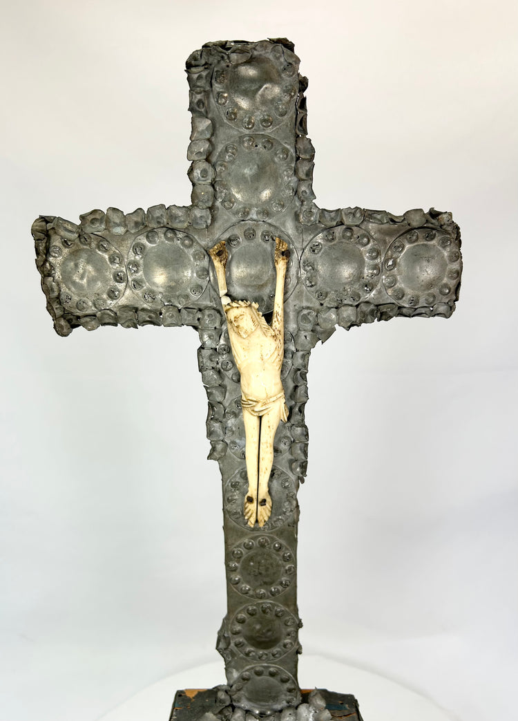 Gilded Christ figure on aged bronze cross — close frontal view.