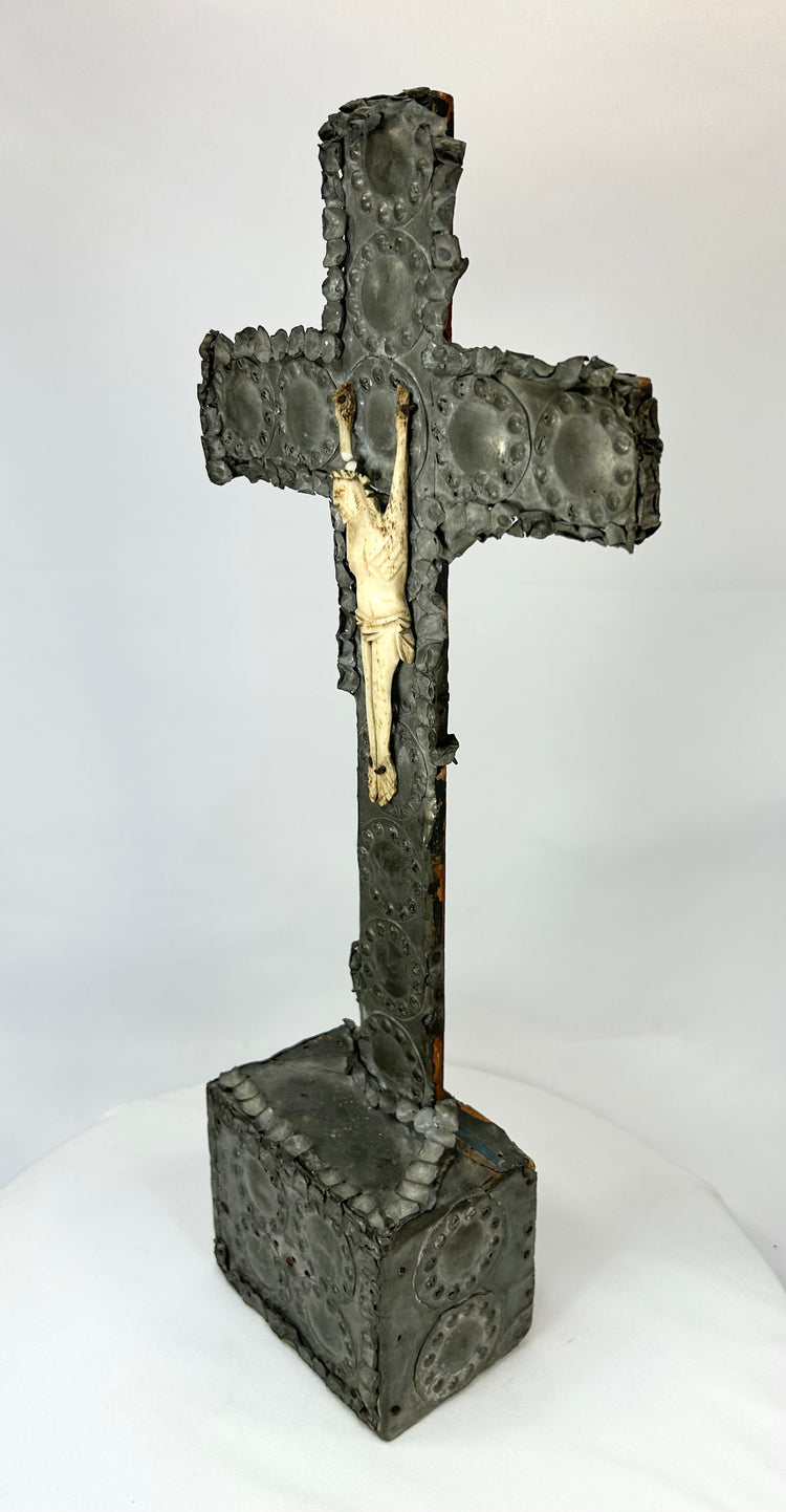 Antique crucifix — three-quarter front view showing gilded highlights and dark patina.