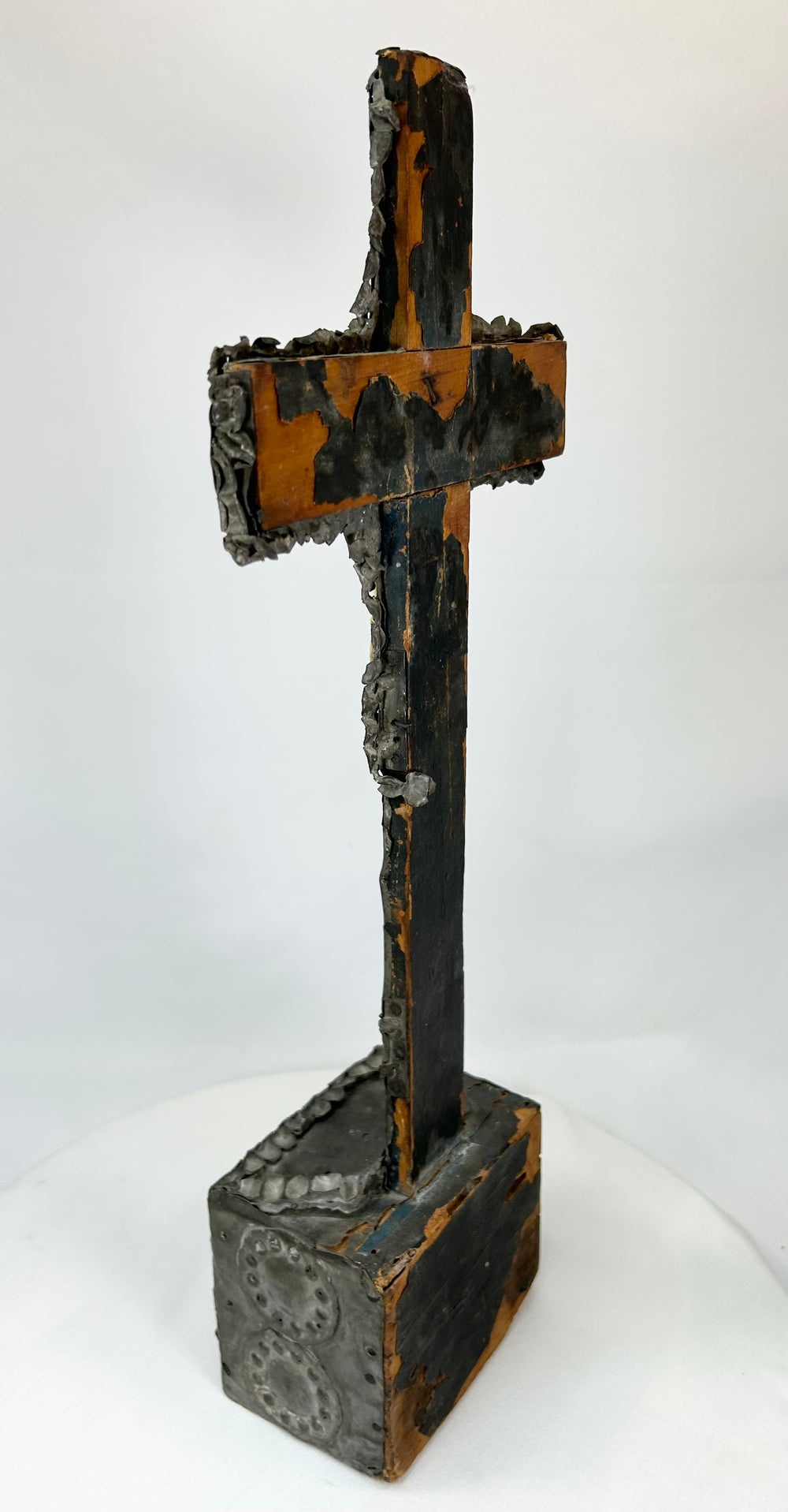 Aged bronze cross — rear view displaying weathered surface and casting marks.