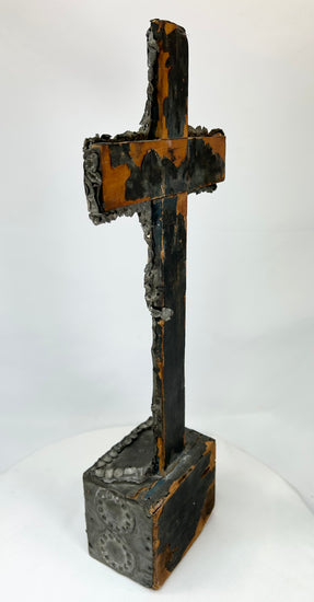 Aged bronze cross — rear view displaying weathered surface and casting marks.