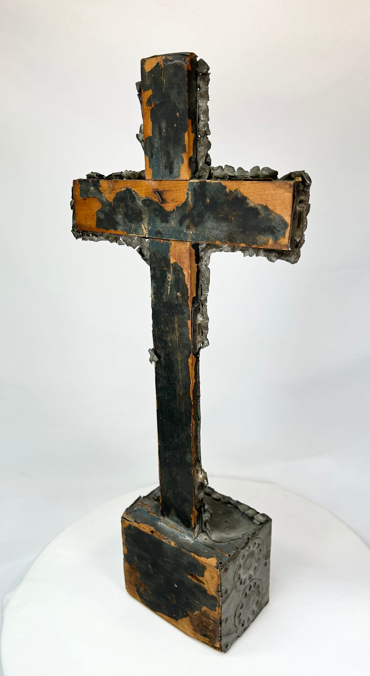 Bronze cross relic — back view on display stand revealing natural patina and form