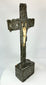 Evocative Spanish Colonial crucifix with tin-covered wood, bone Christ figure, raised rosette motifs, and aged painted reverse, 18 inches high.