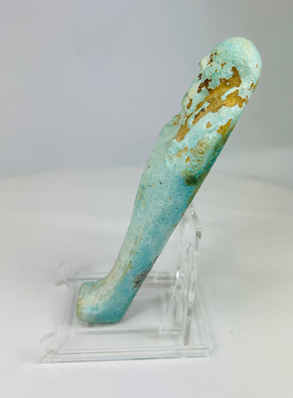 Left side of ancient Egyptian faience ushabti figure with blue-green glaze and visible hieroglyphic column.