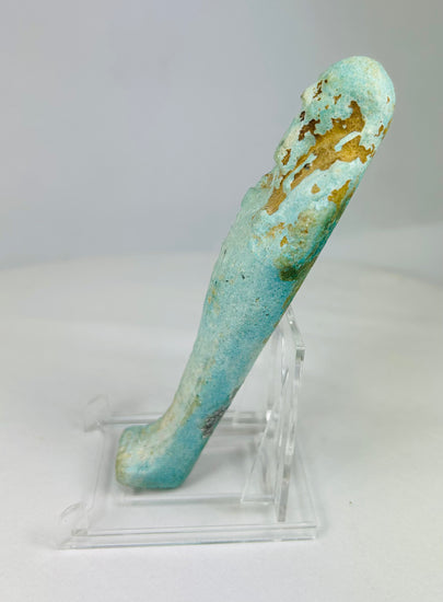 Left side of ancient Egyptian faience ushabti figure with blue-green glaze and visible hieroglyphic column.