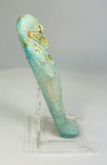 Right side of turquoise-glazed faience ushabti showing ancient surface wear and burial patina.