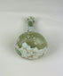 Base of Roman glass bottle with smooth circular finish and aged iridescent surface from antiquity.