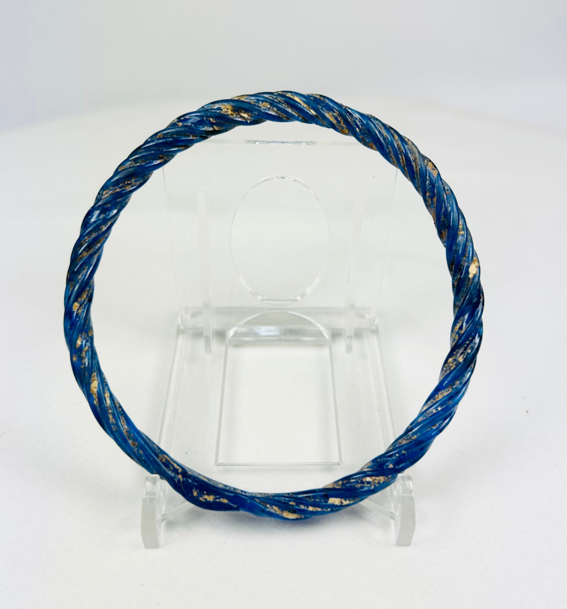 Ancient Roman glass bracelet photographed with visible iridescent sheen and smooth rounded edges.