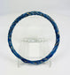 Ancient Roman glass bracelet photographed with visible iridescent sheen and smooth rounded edges.