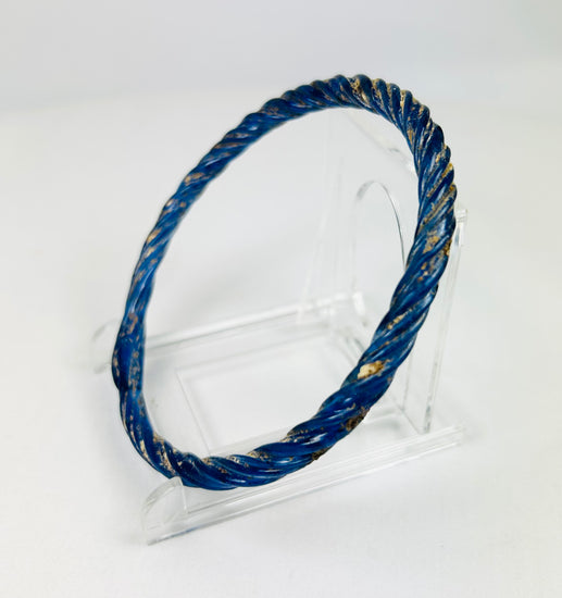 Alternate angled left view of ancient Roman glass bracelet showing smooth curvature and iridescent patina.