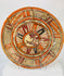 Front view of Mesoamerican polychrome earthenware plate showing central stylized animal design and red-black-cream pigment patterning.