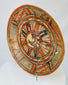 Left-side oblique angle of ancient Mesoamerican polychrome plate showing curvature and painted rim motifs.