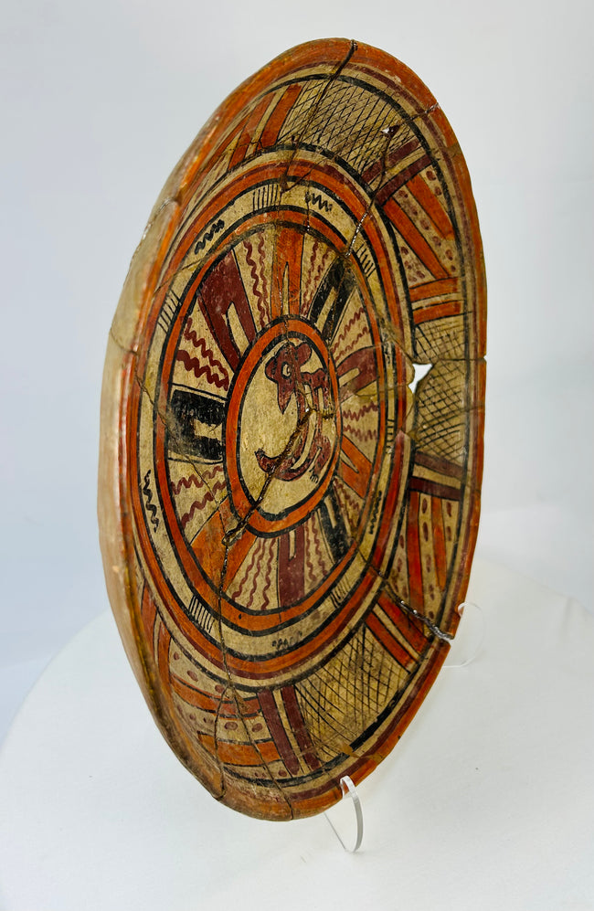 Right-front angle of Mesoamerican ritual plate revealing depth and symmetry of painted composition.